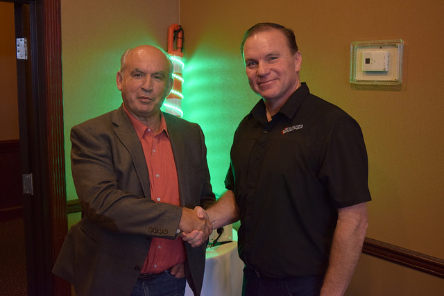 Honourable Bill Bennett, B.C. Minister of Energy and mines is shaking hands with Mike Hambalek.