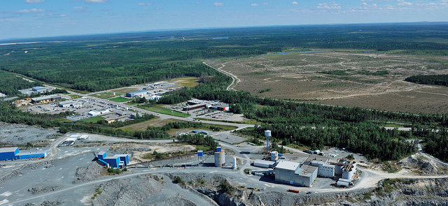 An aerial photo of the Sigma Milling Facility looking Southeast towards the Lamaque South Property.  A drill can be seen operating on the Parallel Zone (the yellow dot within the treeless area). 
