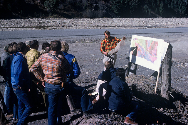 Exploration geologists are instructed by a geology professor from the University of Montana about the exploration potential of Precambrian Belt Series rocks in western Montana in 1978.