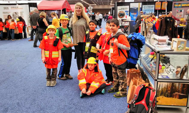 A group of kids in brightly coloured safety gear. 