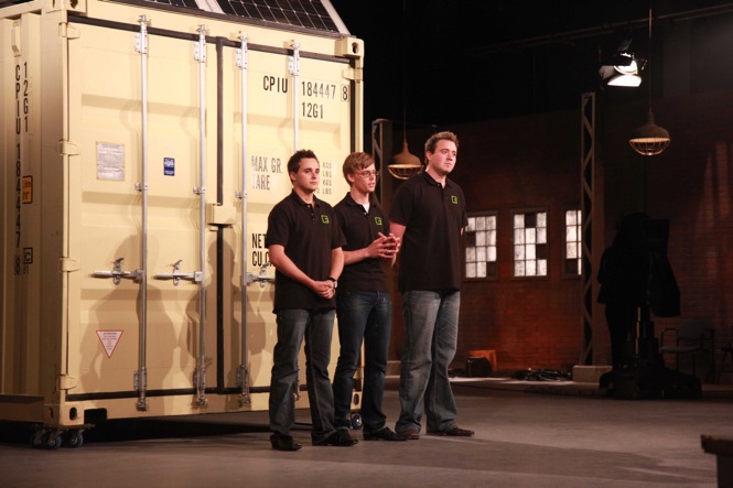 Channing McCorriston, Evan Willouhby and Bryan McCrea standing in front of a shipping container