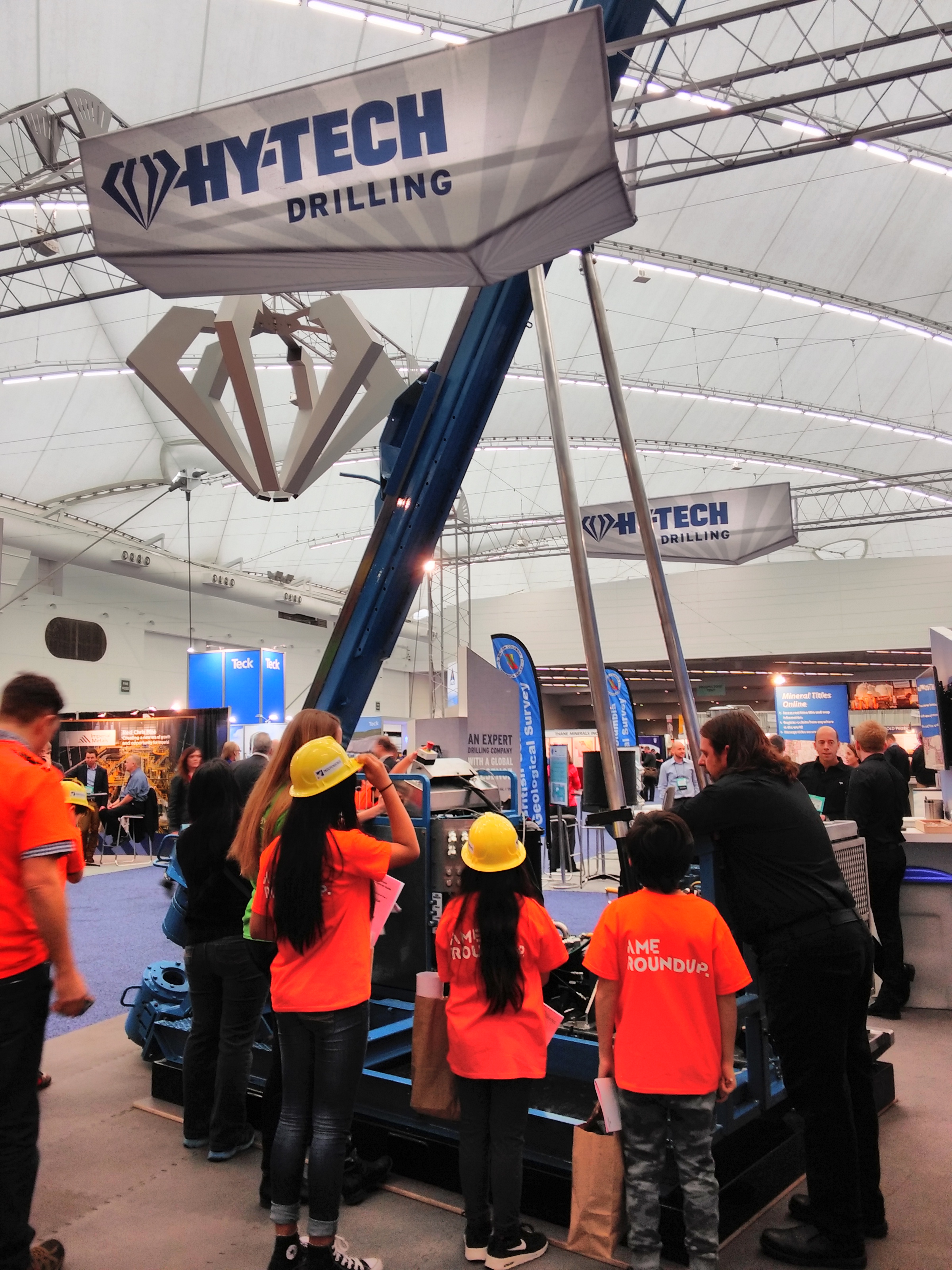 Hy-Tech Drilling Ltd. displayed a tall eye-catching drill. Students and their guide are given an explanation of how a drill is used in the field. 