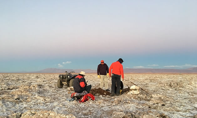 A group of people working in a dry, desert area. 