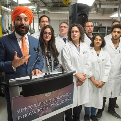 Federal Minister Navdeep Bains discussing the supercluster program at a news conference. 
