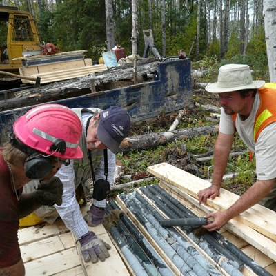 Workers examine core samples at the Sollas Lake Property. 