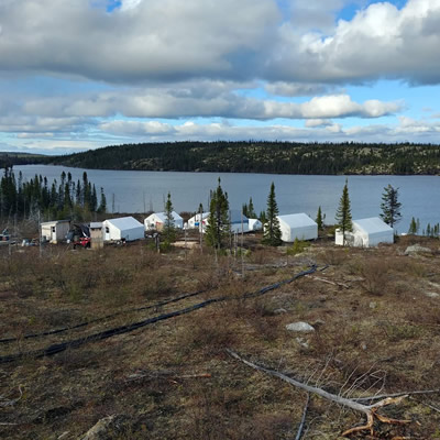 View of small mining camp, overlooking lake. 