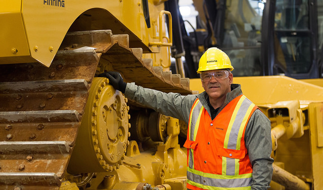 Tony de Sousa, standing next to a Finning Cat, will oversee Finning Canada's operations in Saskatchewan from Caterpillar's provincial headquarters in Regina.