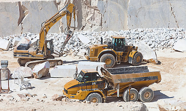 Picture of heavy equipment working in rock quarry. 