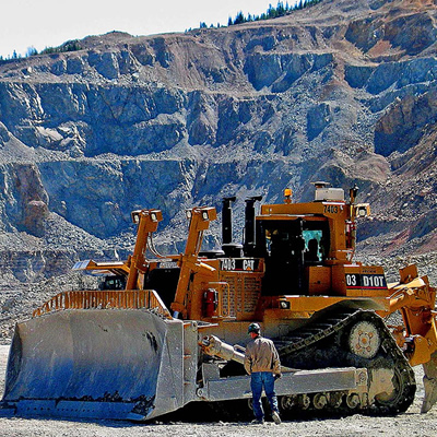 Picture of large yellow bulldozer at Highland Valley Copper mine in Logan Lake. 