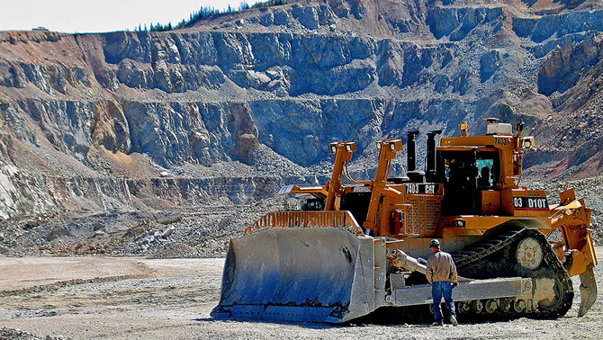 Picture of large yellow bulldozer at Highland Valley Copper mine in Logan Lake. 