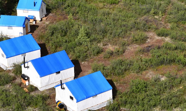 Overhead view of portable mining accommodations with blue roofs. 