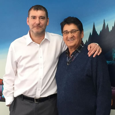 Jamie Saulnier and former National Chief Ovide Mercredi, Running Deer Resources advisory board member, are standing together.