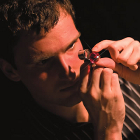 Photo of Jeff Nechka man studies a gem with a special magnifying glass