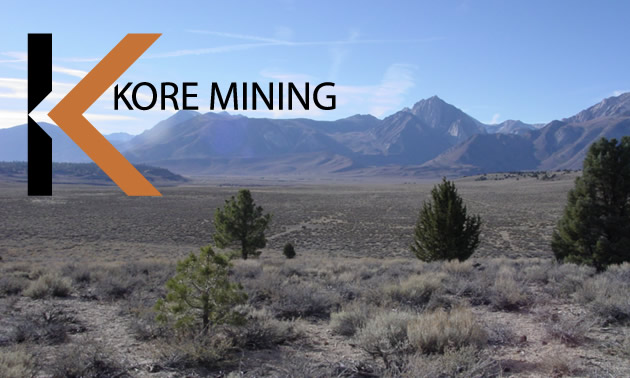 KORE Mining logo and picture of arid valley. 