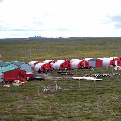 Aerial view of Kennady Diamond camp, showing red buildings with grassland vista. 
