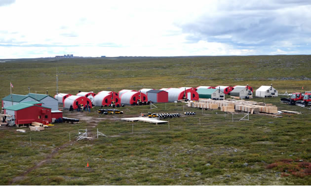 Aerial view of Kennady Diamond camp, showing red buildings with grassland vista. 