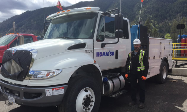 Steven Droste, Komatsu’s Regional Manager – Western Canada, stands with one of the company's service vehicles. 