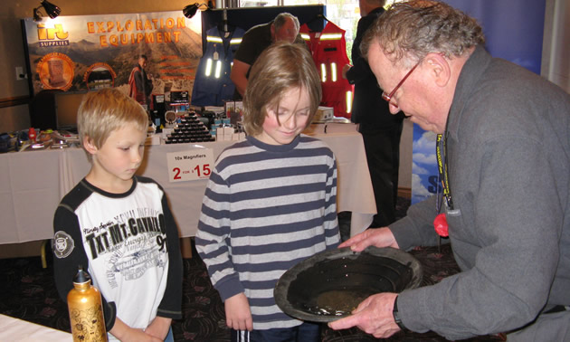 Photo of two children observing a gold pan demonstration
