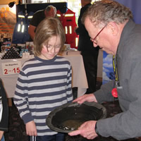 Photo of two children observing a gold pan demonstration