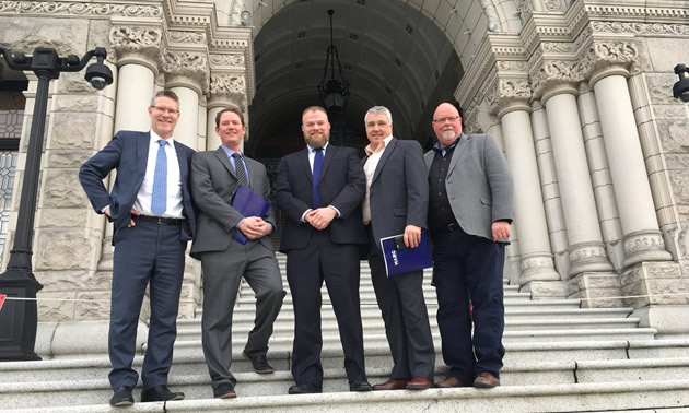 Pictured is one of 10 teams for Mining Day, standing in front of the legislature. Left to right: AME president and CEO, Gavin Dirom; Kal Tire regional sales manager, Kevin Frame; MSABC president and CEO, Alec Morrison; Wajax director of mining, Todd Sams; and general manager of Conuma Coal Resources, Al Kangas.
