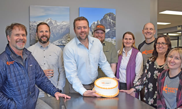 Group of North Coal employees celebrating and holding a cake. 