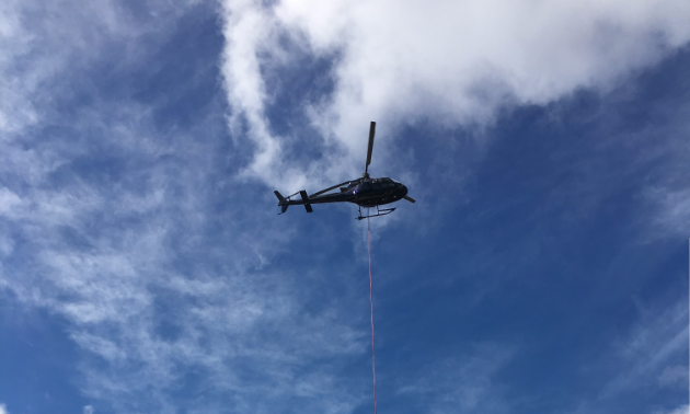 A helicopter is slinging casings for Avataa Rouillier Drilling's current drilling operation south of Kuujjuaq in Nunavik.