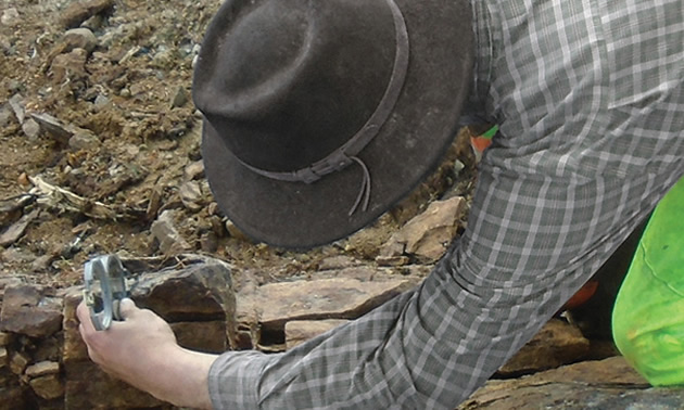 Worker studying rock samples. 