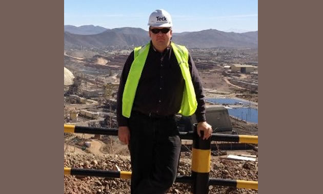 Teck's Michael Davies, VP of Enviroment and Sustainability at the company, standing with mine view behind him