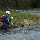A Teck employee conducts water sampling near the company’s Greenhills Operations. 