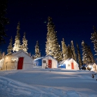 A camp with tents during a cold winter night. 