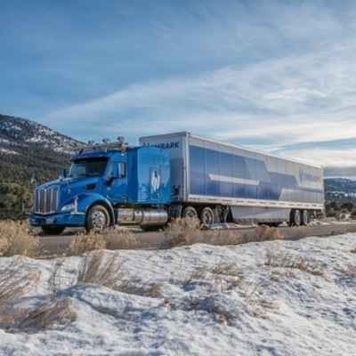 A long-haul truck on a snowy day. 