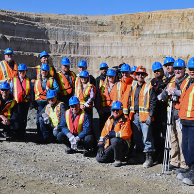 Guests pause during a tour of the Victor Mine pit for a photograph. The pit was one of several stops along the tour including the Process Plant, Reclamation areas, and more.