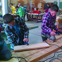 Photo of grade 9 students testing their skills in College of the Rockies’ carpentry shop.