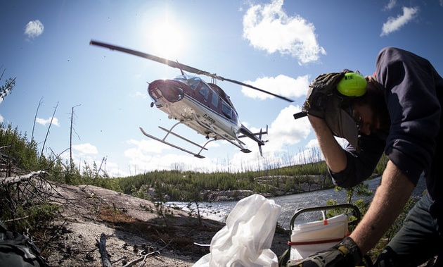 A helicopter picking up till samples. 