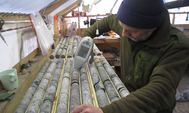 Avalon geologist Chris Pederson measures rare earth element concentrations using a hand-held XRF analyzer in diamond-drill core from the Nechalacho project. Samples are then sent to a laboratory for more precise analysis. 
