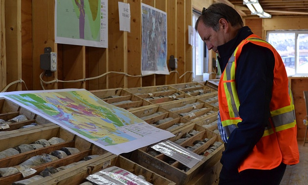 The president and chief executive officer of Pretium Resources Inc., Robert Quartermain, examines a site map and core samples at Pretium's Brucejack project, 65 km north of Stewart, British Columbia.