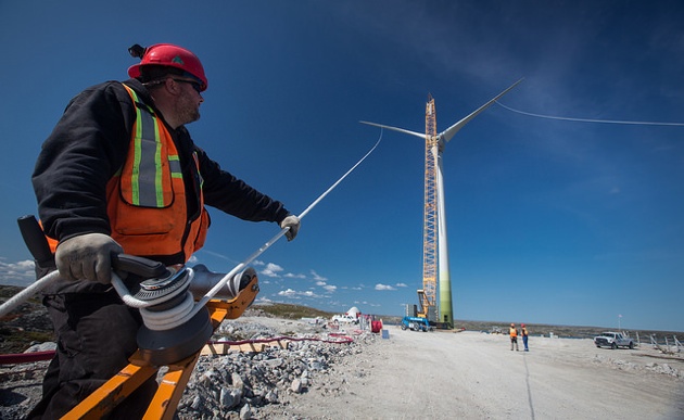 A group working together to assemble one of the wind turbines.