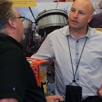 Two delegates networking at the tradeshow. 