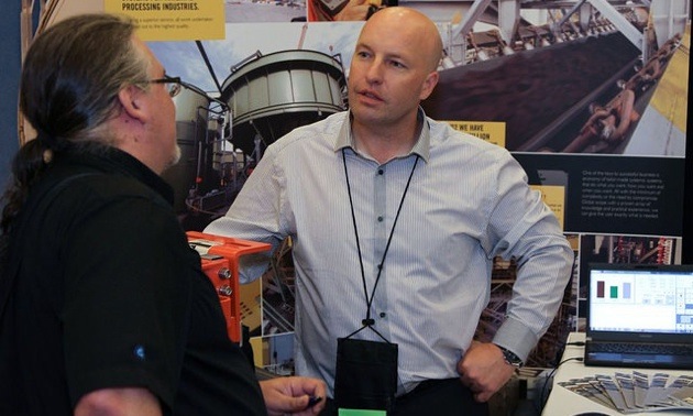 Two delegates networking at the tradeshow. 