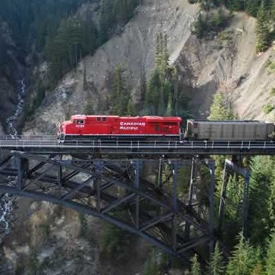 A CP Rail train travelling over a bridge. 