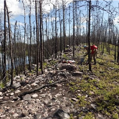 De Beers geologist collecting samples from esker at West Athabasca.