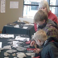 2 children looking at a display with interest at the Minerals South Conference.