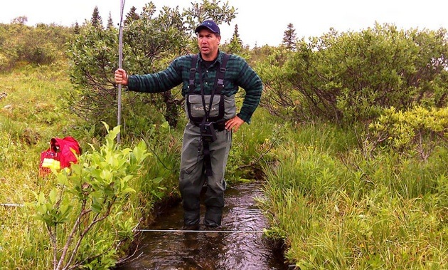 Selwyn’s fishery biologist studying local stream flows for environmental assessment.