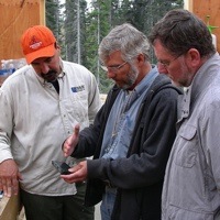 Ron Britten, centre, First Point Minerals Corp.'s vice-president of
exploration, examines some awaruite core samples at the Decar
Project's core shack along with two officials from Cliffs Natural
Resources Exploration Canada Inc. 