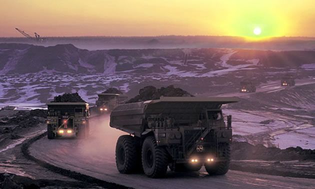 Photo mining vehicles and background sunset
