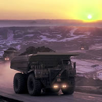 Photo mining vehicles and background sunset