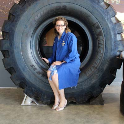 Jennifer Beaudry, sitting on large tire.