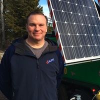 Mike Hambalek by Soleco's second generation solar and wind-powered light tower.
