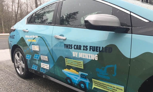 MABC's electric car is wrapped in messages that explain what materials are mined to create a single car.