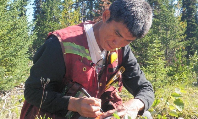 Student from the WEST program in 2013 collects data in the field.
